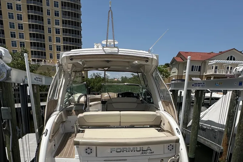 Slide: The Image of 2019 Formula 350 Crossover Bowrider docked near waterfront buildings. - 13