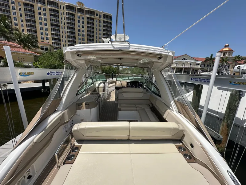 Slide: The Image of 2019 Formula 350 Crossover Bowrider docked, featuring spacious seating and elegant design. - 15