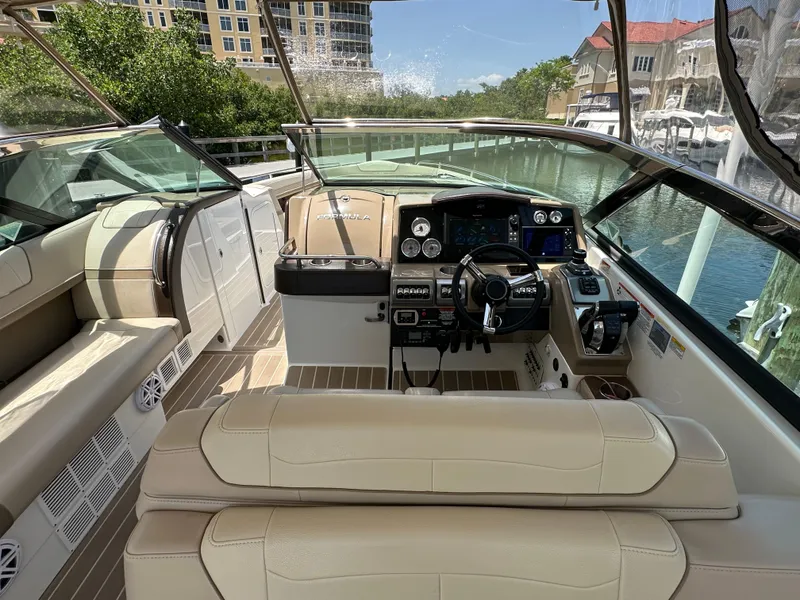 Slide: The Image of 2019 Formula 350 Crossover Bowrider interior with beige seating and modern dashboard controls. - 18