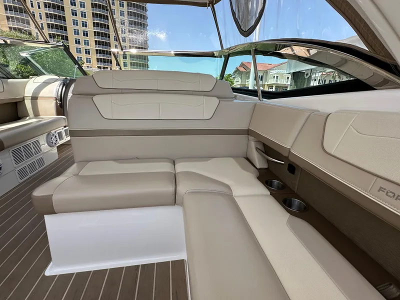 Slide: The Image of 2019 Formula 350 Crossover Bowrider interior with beige seating and cup holders. - 20