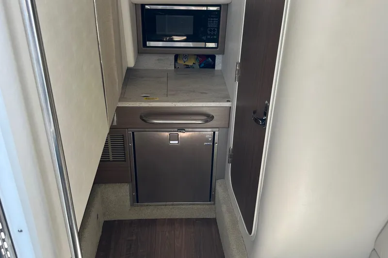 Slide: The Image of 2019 Formula 350 Crossover Bowrider interior with microwave and mini fridge. - 23