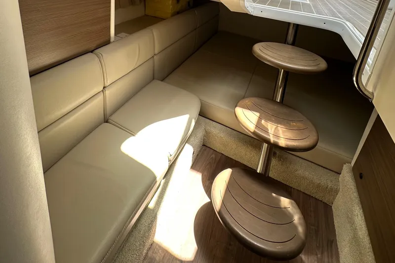 Slide: The Image of 2019 Formula 350 Crossover Bowrider interior with beige seating and wooden steps. - 26