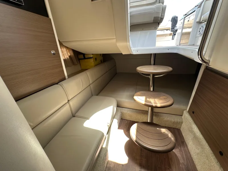 Slide: The Image of 2019 Formula 350 Crossover Bowrider interior with beige seating and wooden steps. - 27
