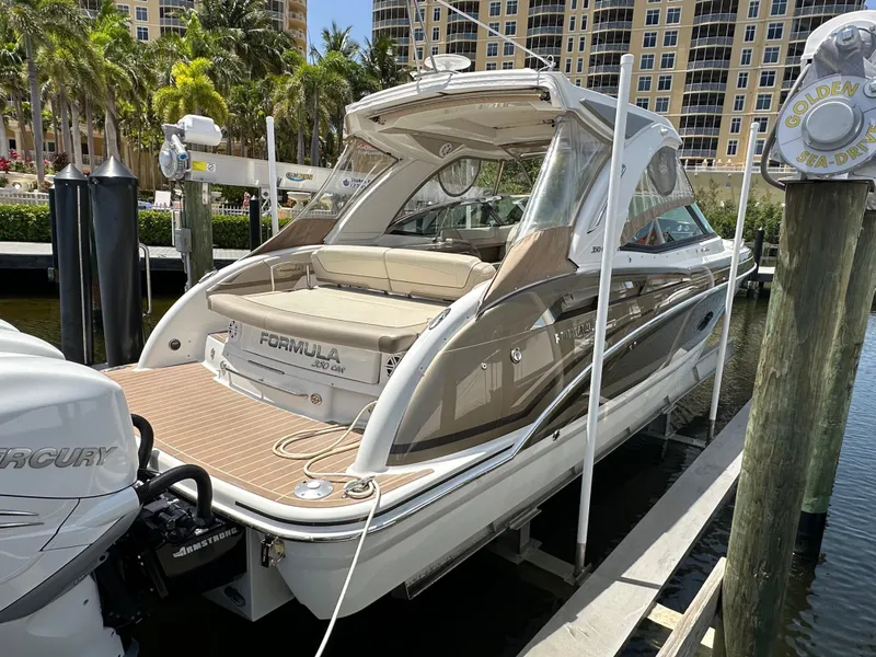 Slide: The Image of 2019 Formula 350 Crossover Bowrider docked, showcasing sleek design and spacious seating. - 3