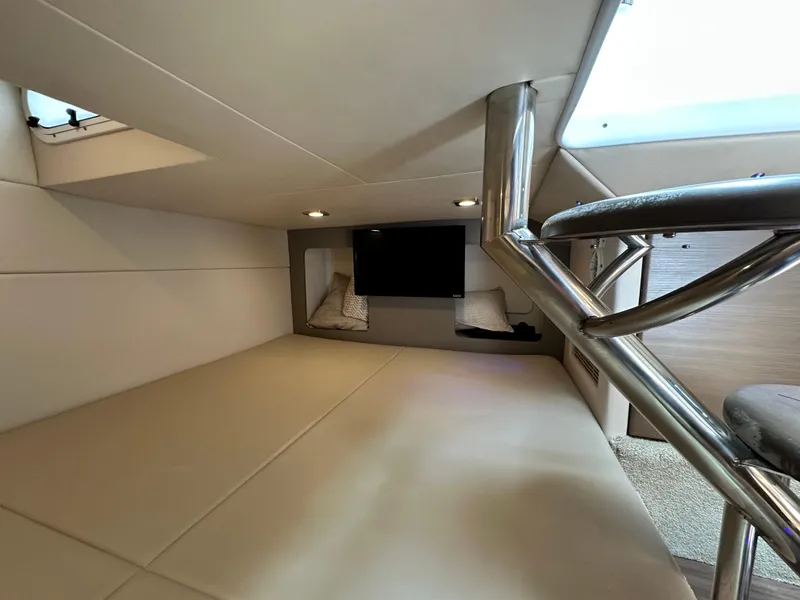 Slide: The Image of 2019 Formula 350 Crossover Bowrider cabin interior with bed, TV, and modern design. - 30