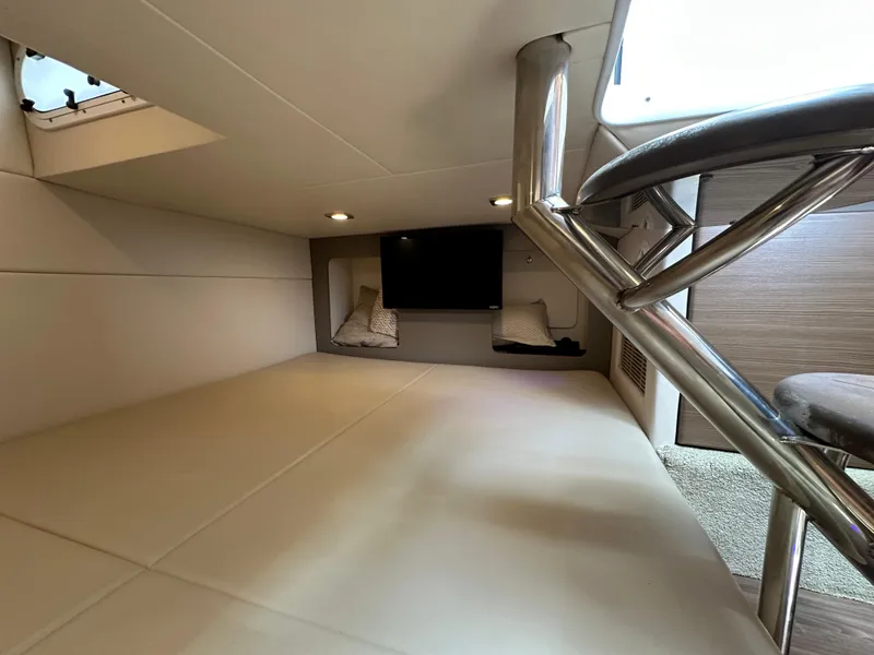 Slide: The Image of 2019 Formula 350 Crossover Bowrider cabin interior with TV and seating. - 32