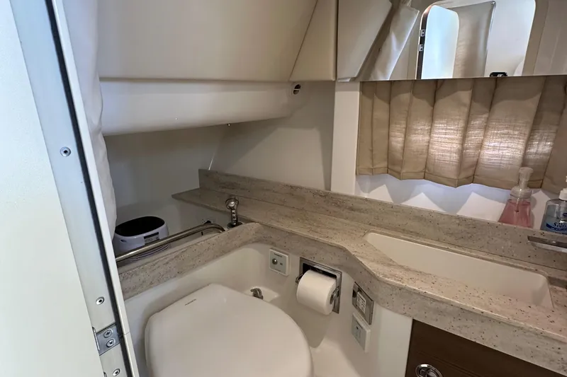 Slide: The Image of 2019 Formula 350 Crossover Bowrider bathroom with sink, toilet, and window. - 34