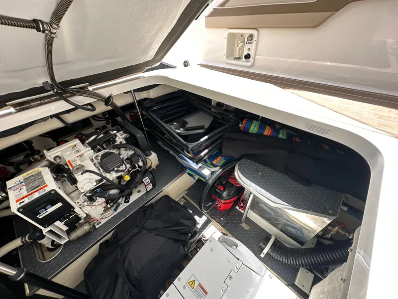 Slide: The Image of 2019 Formula 350 Crossover Bowrider engine compartment with equipment and storage. - 35