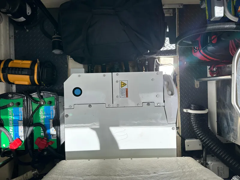 Slide: The Image of Engine compartment of a 2019 Formula 350 Crossover Bowrider with visible batteries and equipment. - 36