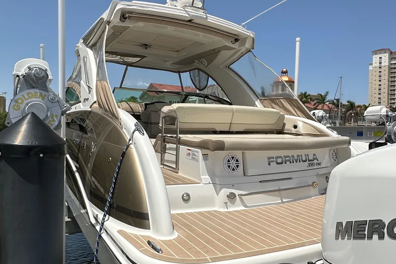 Slide: The Image of 2019 Formula 350 Crossover Bowrider docked, showcasing sleek design and spacious seating. - 4