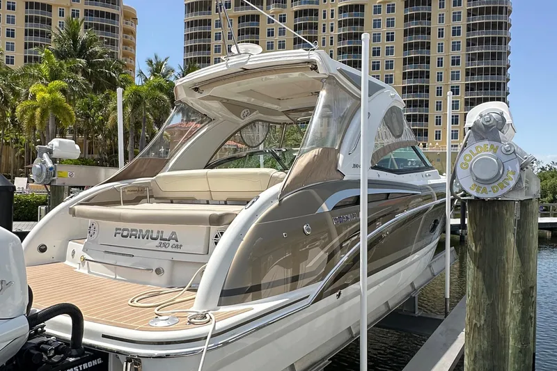 Slide: The Image of 2019 Formula 350 Crossover Bowrider docked near luxury buildings and palm trees. - 5