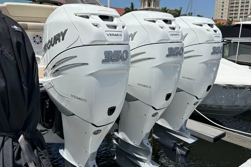 Slide: The Image of Triple Mercury Verado 350 engines on a 2019 Formula 350 Crossover Bowrider at a marina. - 7