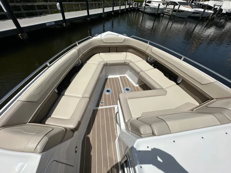 Slide: The Image of 2019 Formula 350 Crossover Bowrider with spacious seating at a marina dock. - 9