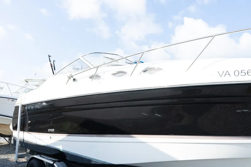 Slide: The Image of 2004 Regal Commodore 2765 boat on trailer under a clear sky. - 10