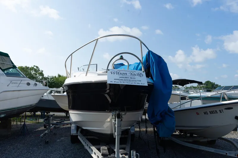 Slide: The Image of 2004 Regal Commodore 2765 boat on trailer, covered, with Wilson Yachts sign. - 12