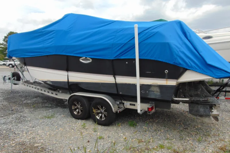 Slide: The Image of 2004 Regal Commodore 2765 boat covered with blue tarp on trailer. - 15