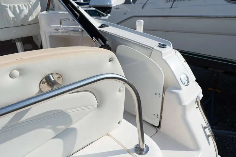 Slide: The Image of 2004 Regal Commodore 2765 boat interior with white seating and stainless steel railing. - 18