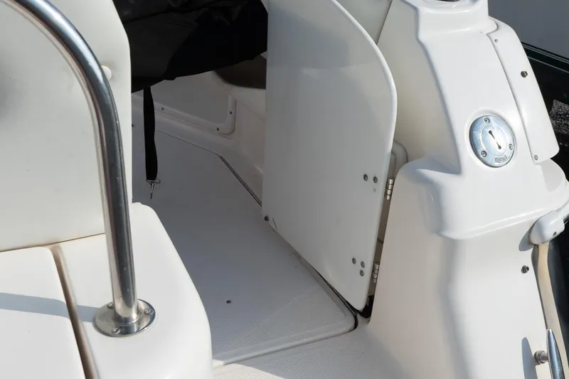 Slide: The Image of 2004 Regal Commodore 2765 boat interior with white seating and stainless steel railing. - 19