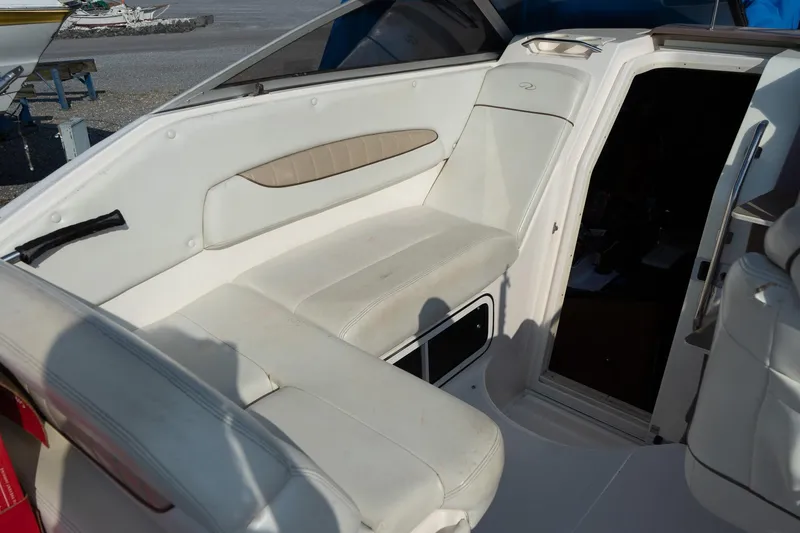 Slide: The Image of 2004 Regal Commodore 2765 boat interior with white seating and cabin entrance. - 20