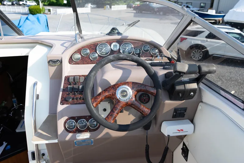 Slide: The Image of 2004 Regal Commodore 2765 boat dashboard with steering wheel and control panel. - 22