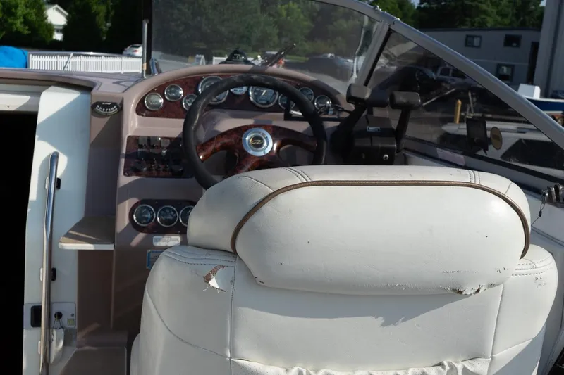 Slide: The Image of Interior of 2004 Regal Commodore 2765 boat showing steering wheel and dashboard controls. - 23