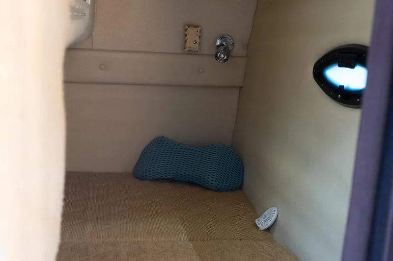 Slide: The Image of Interior cabin of 2004 Regal Commodore 2765 boat with cushion and porthole. - 28