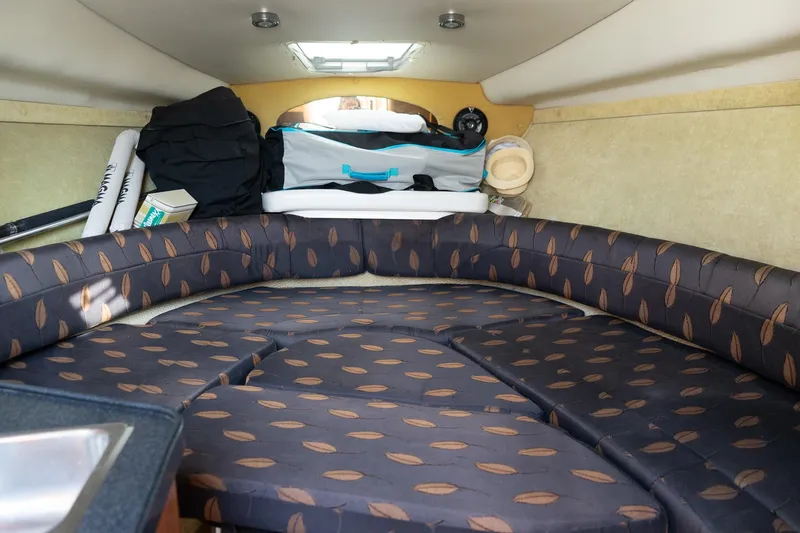 Slide: The Image of Interior cabin of 2004 Regal Commodore 2765 boat with patterned seating and storage. - 29