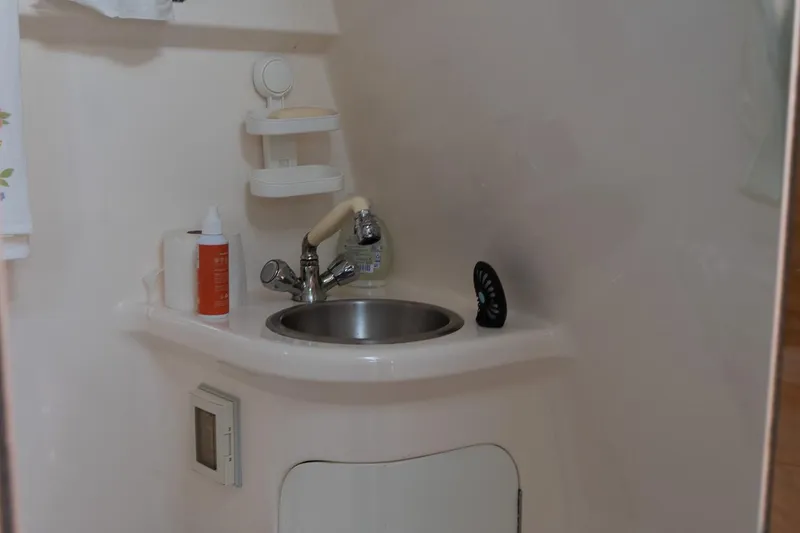 Slide: The Image of Compact bathroom sink in 2004 Regal Commodore 2765 boat interior. - 34