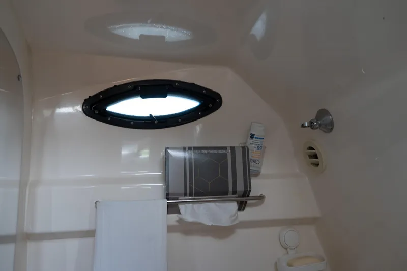 Slide: The Image of Bathroom interior of 2004 Regal Commodore 2765 boat with porthole and towel rack. - 36