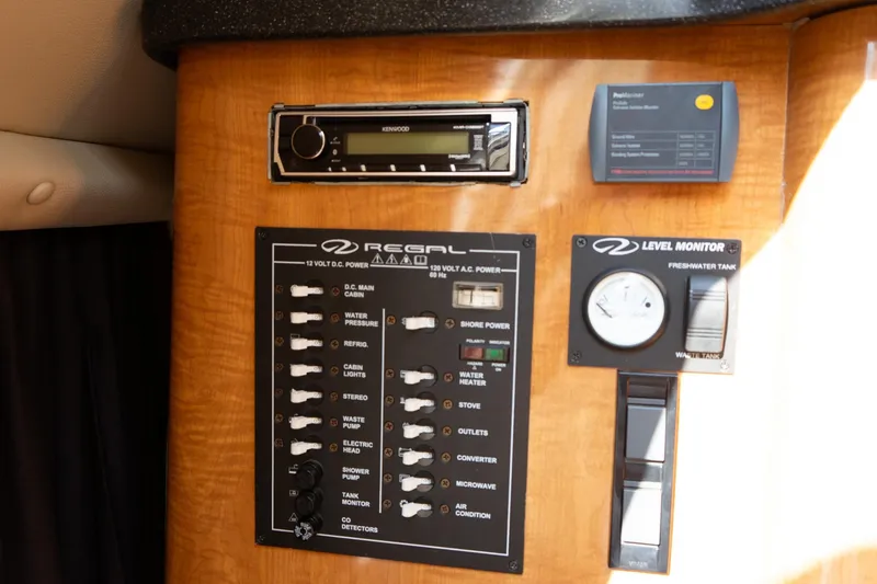 Slide: The Image of Control panel of a 2004 Regal Commodore 2765 boat with various switches and gauges. - 37