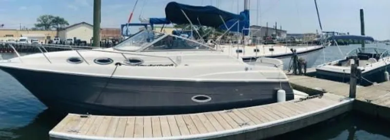 Slide: The Image of 2004 Regal Commodore 2765 boat docked at marina, clear sky, calm water. - 5