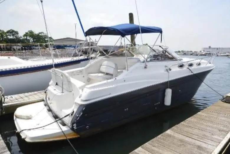 Slide: The Image of 2004 Regal Commodore 2765 boat docked at marina with blue canopy. - 6