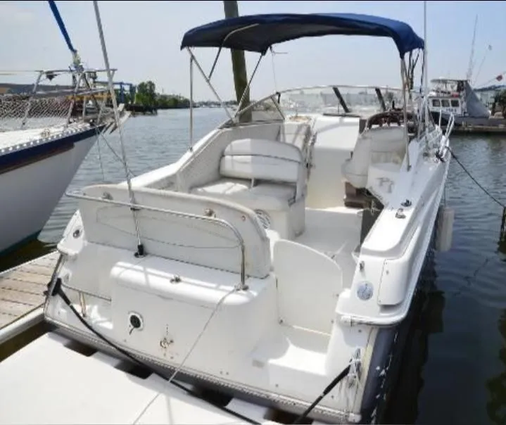 Slide: The Image of 2004 Regal Commodore 2765 boat docked, featuring spacious seating and canopy. - 8