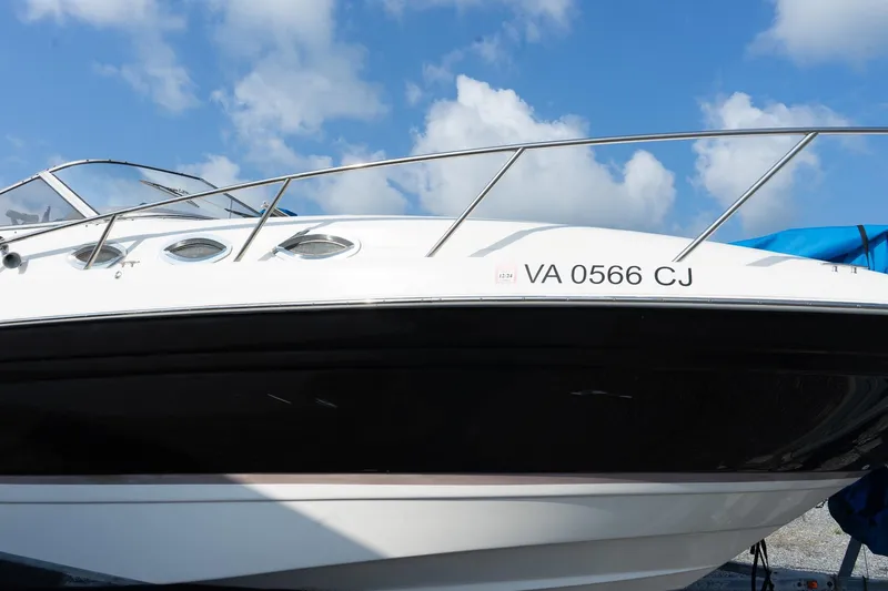 Slide: The Image of 2004 Regal Commodore 2765 boat with registration VA 0566 CJ under a blue sky. - 9
