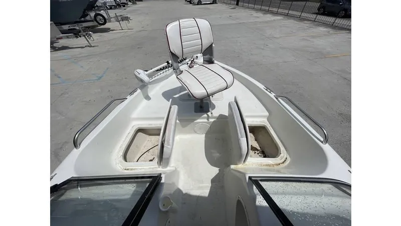 Slide: The Image of 2002 Bay Stealth 1880 boat with swivel seat and storage compartments on deck. - 11