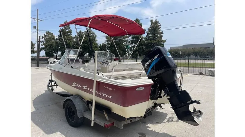 Slide: The Image of 2002 Bay Stealth 1880 boat with red canopy and Mercury outboard motor on trailer. - 4