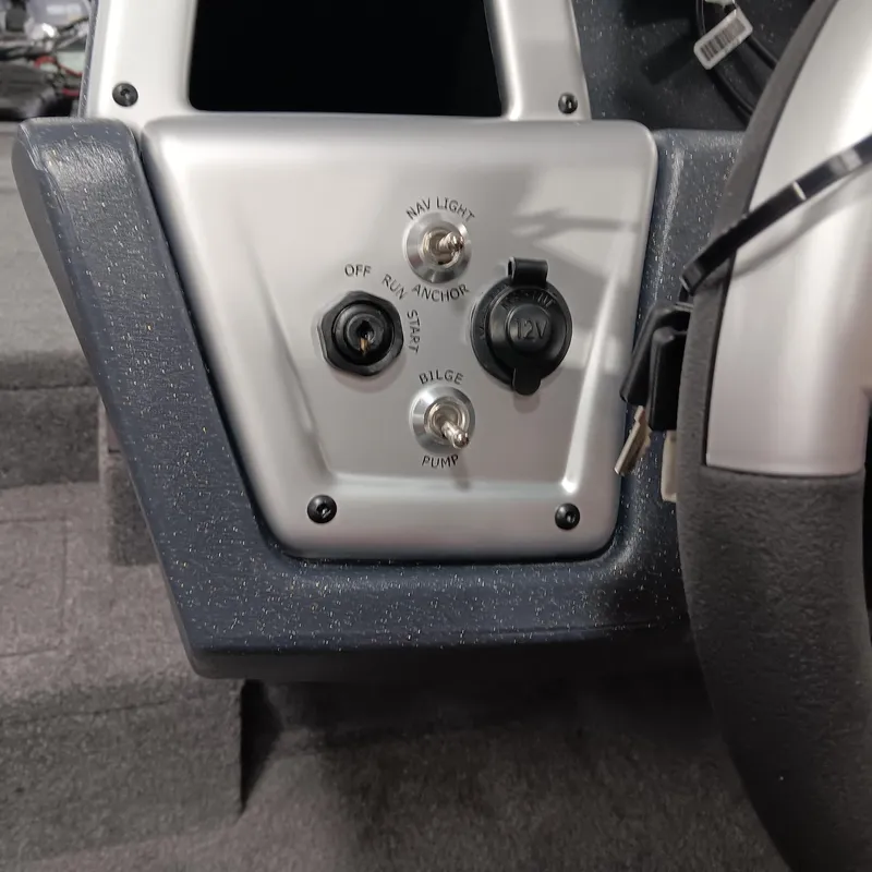 Slide: The Image of Control panel of 2025 Tracker Pro Team 175 boat with switches and steering wheel. - 10