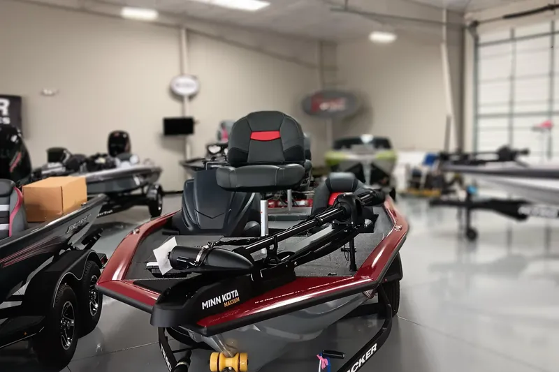 Slide: The Image of 2025 Tracker Pro Team 175 boat in showroom, featuring Minn Kota trolling motor. - 4