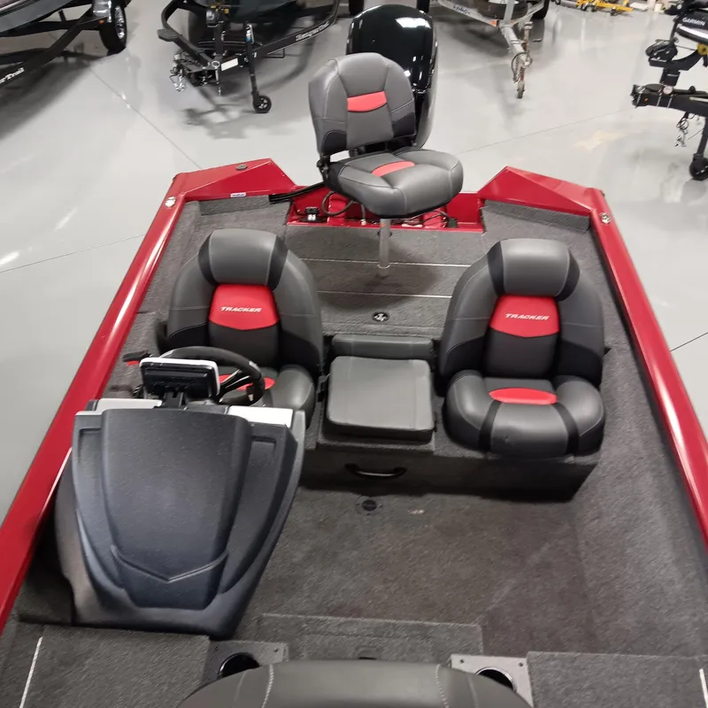 Slide: The Image of 2025 Tracker Pro Team 175 boat interior with red and black seating, steering console, and storage. - 8