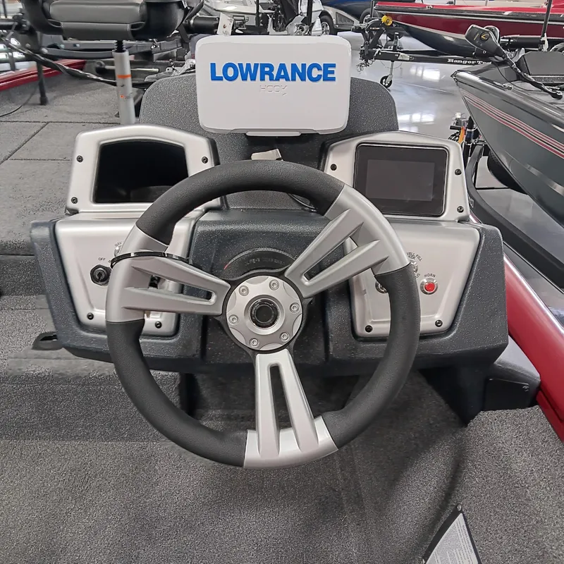Slide: The Image of 2025 Tracker Pro Team 175 boat dashboard with Lowrance electronics and steering wheel. - 9