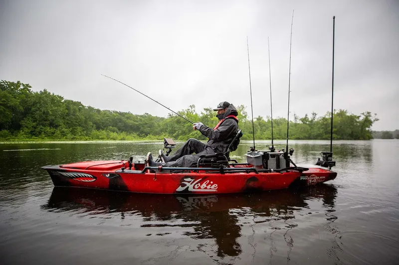 Slide: The Image of Angler fishing on a 2025 Hobie PRO ANGLER 14 360 kayak in a serene lake. - 4