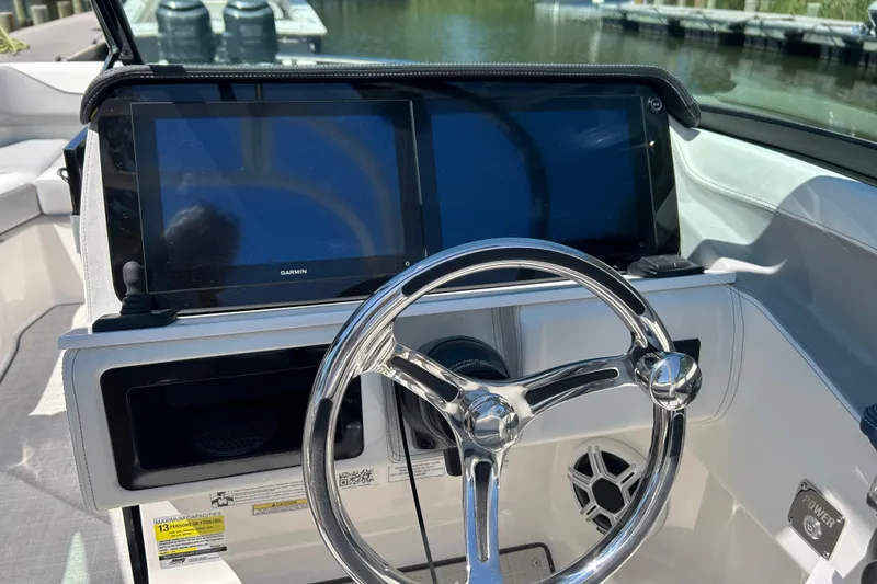 Slide: The Image of Steering wheel and dual screens on 2026 Regal LX4 boat dashboard. - 12