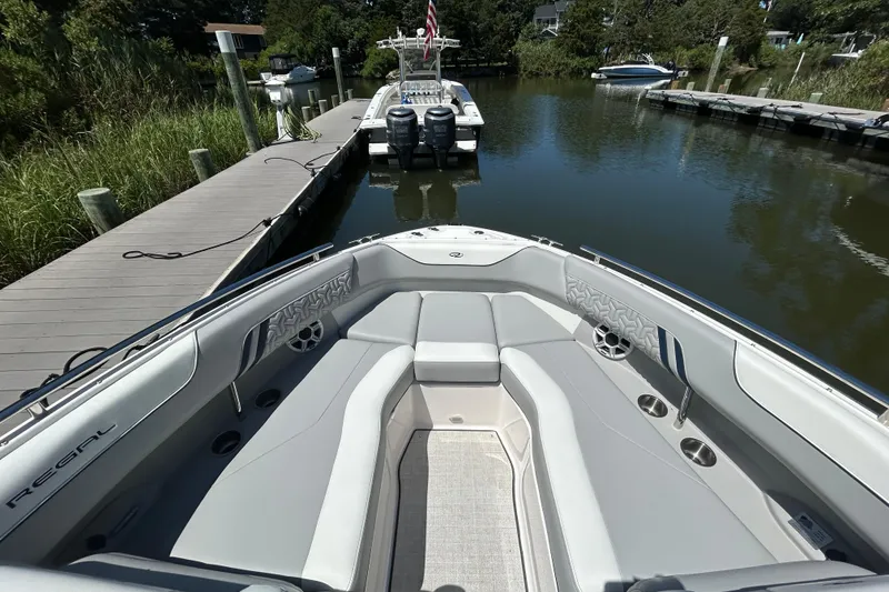 Slide: The Image of 2026 Regal LX4 boat interior at dock, featuring sleek seating and modern design. - 14