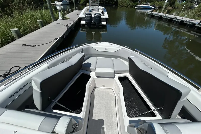 Slide: The Image of 2026 Regal LX4 boat interior with open storage compartments at a dock. - 15