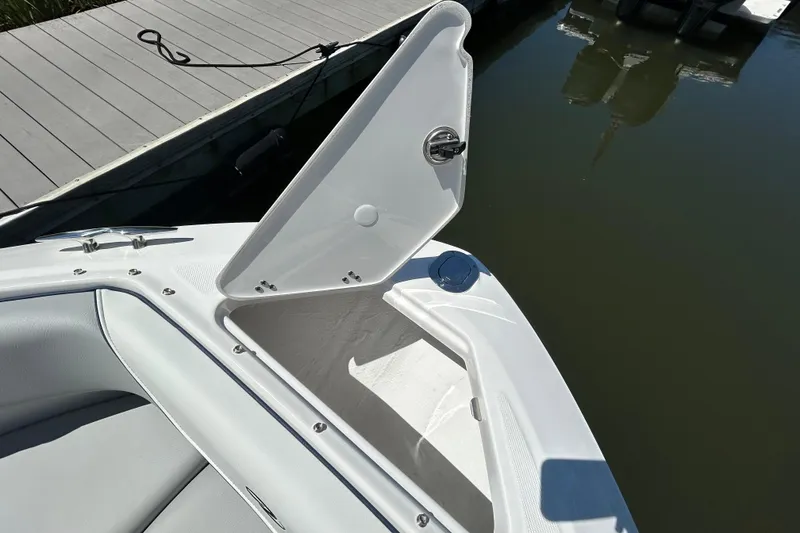 Slide: The Image of Open storage compartment on 2026 Regal LX4 boat by the dock. - 16