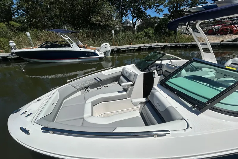 Slide: The Image of 2026 Regal LX4 boat docked, featuring sleek design and spacious seating. - 19
