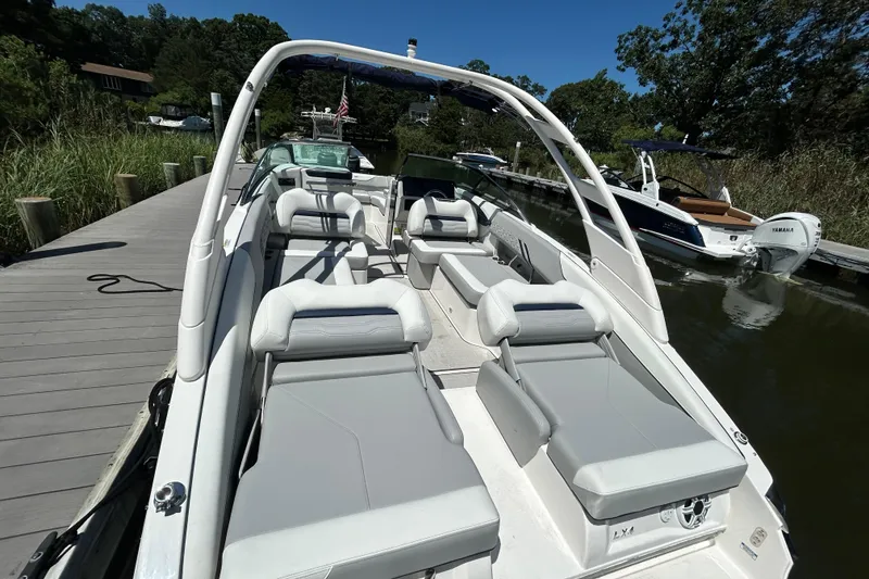 Slide: The Image of 2026 Regal LX4 boat docked, featuring spacious seating and sleek design. - 3
