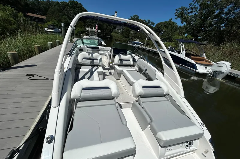 Slide: The Image of 2026 Regal LX4 boat docked, featuring sleek seating and modern design. - 4