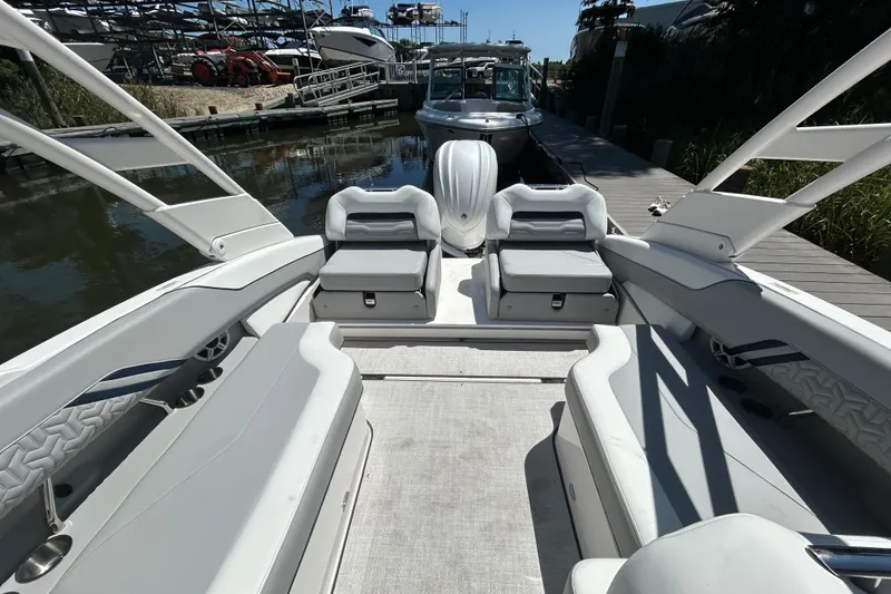 Slide: The Image of 2026 Regal LX4 boat interior with sleek seating and modern design at a dock. - 5