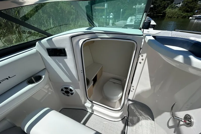 Slide: The Image of 2026 Regal LX4 boat interior with open door to compact bathroom. - 9
